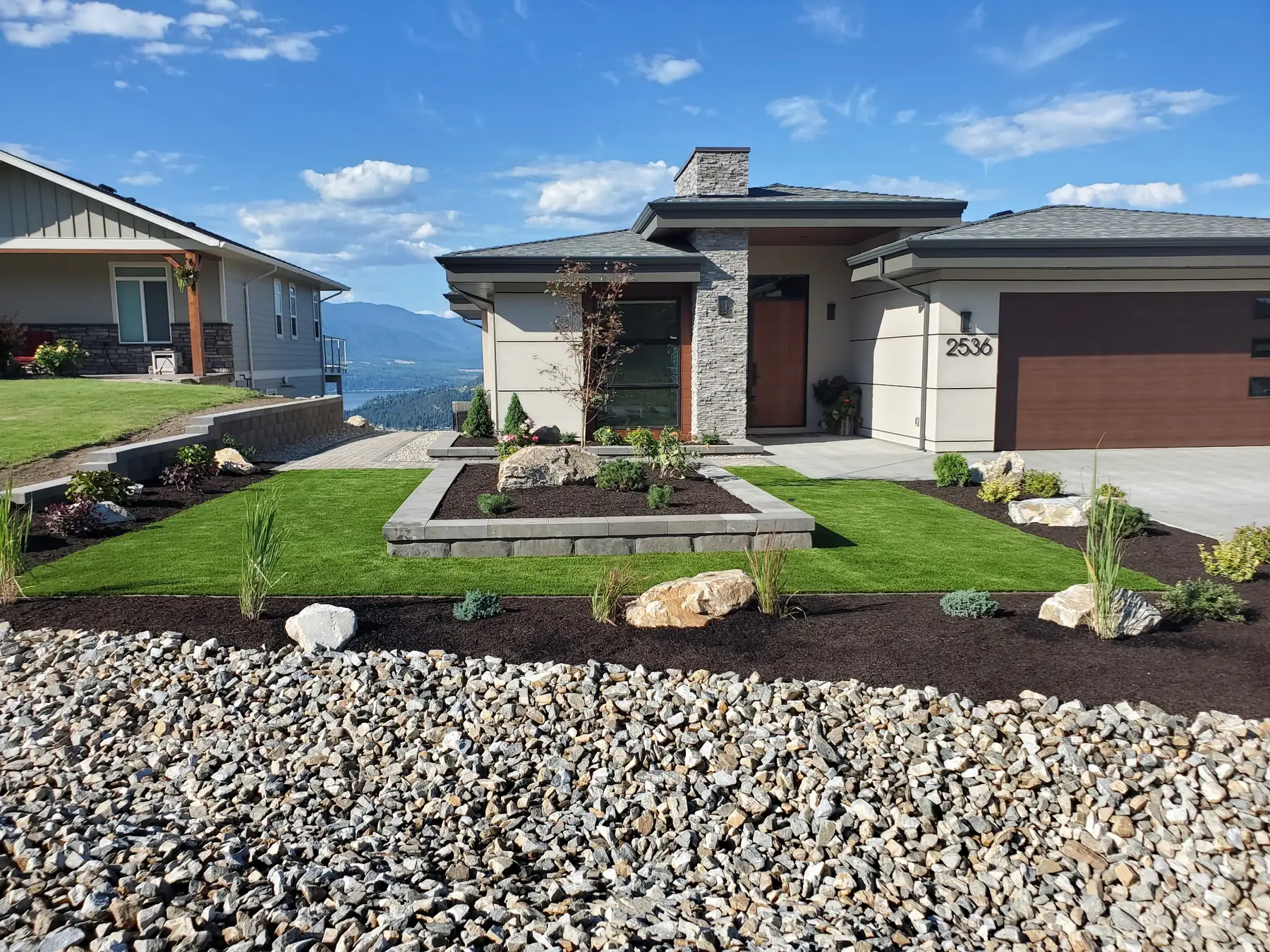 Front-yard landscape build with boulder accents, lawn and Shuswap lake views, Salmon Arm BC