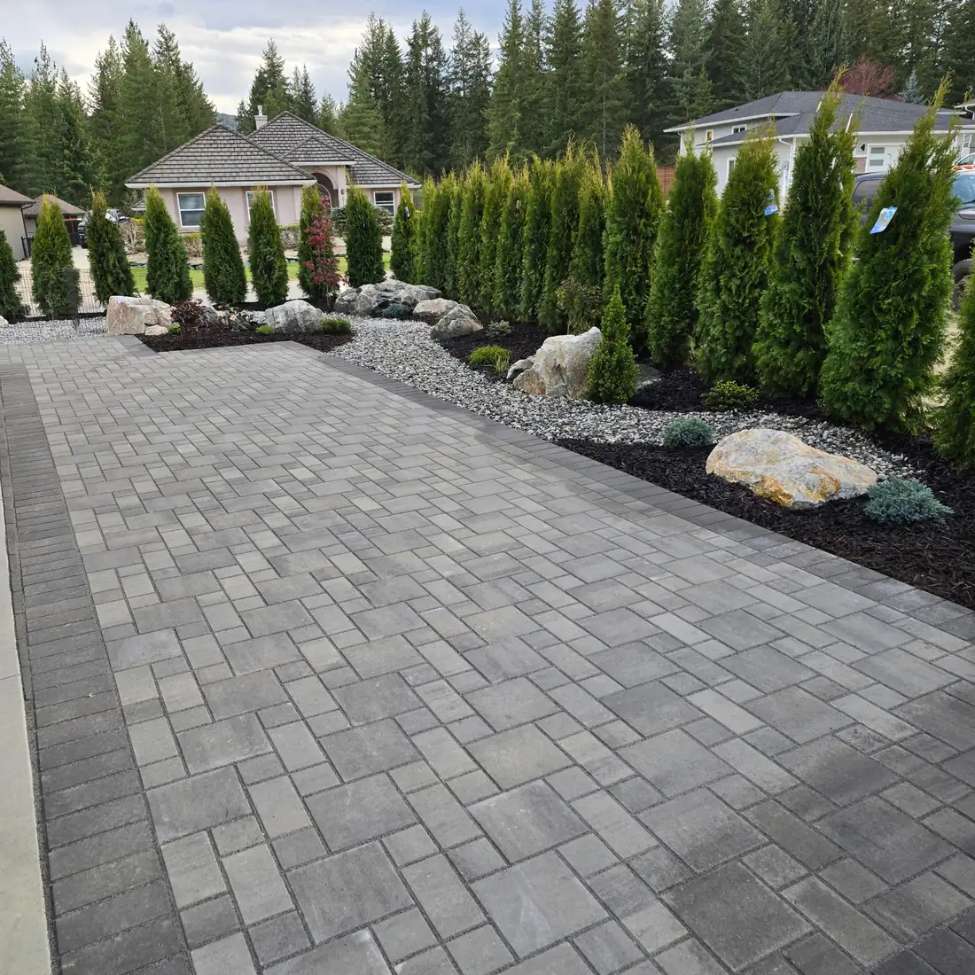 Paver walkway with boulder and cedar planting, Salmon Arm BC